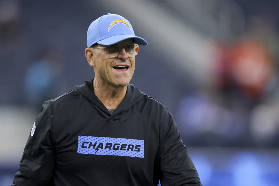 Los Angeles Chargers head coach Jim Harbaugh walks on the field before an NFL football game against the Denver Broncos, Thursday, Dec. 19, 2024, in Inglewood, Calif. (AP Photo/Ryan Sun)